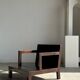 Small low armchair in varnished brown wood