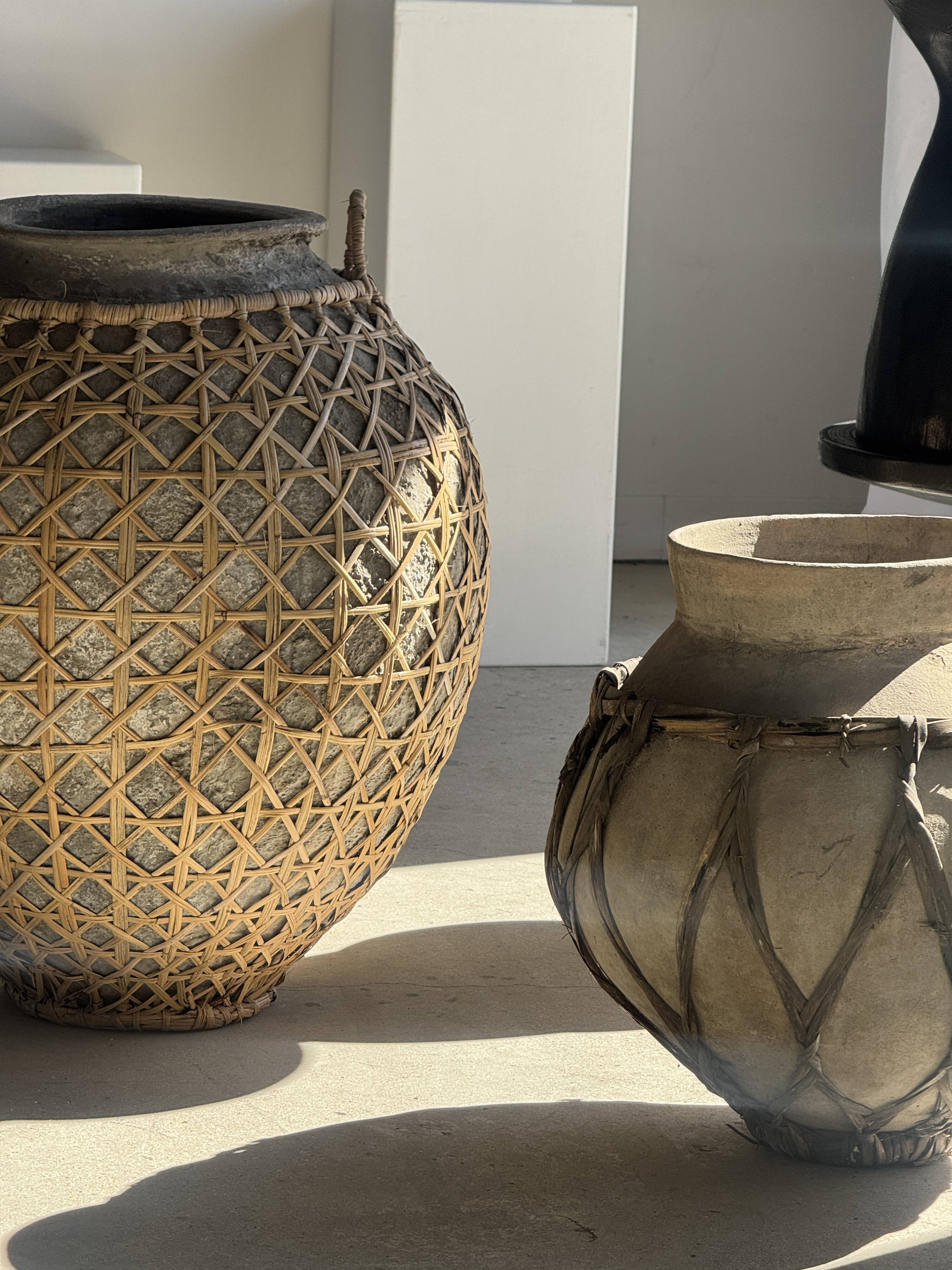 Immense light grey antique-style pot with a crosshatch lid and handles.