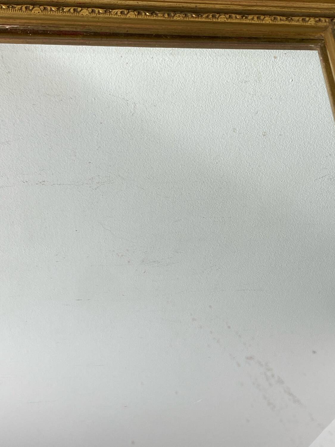 Antique mirror in carved gilded wood