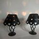Pair of black wrought iron lanterns with heart patterns, romantic style.