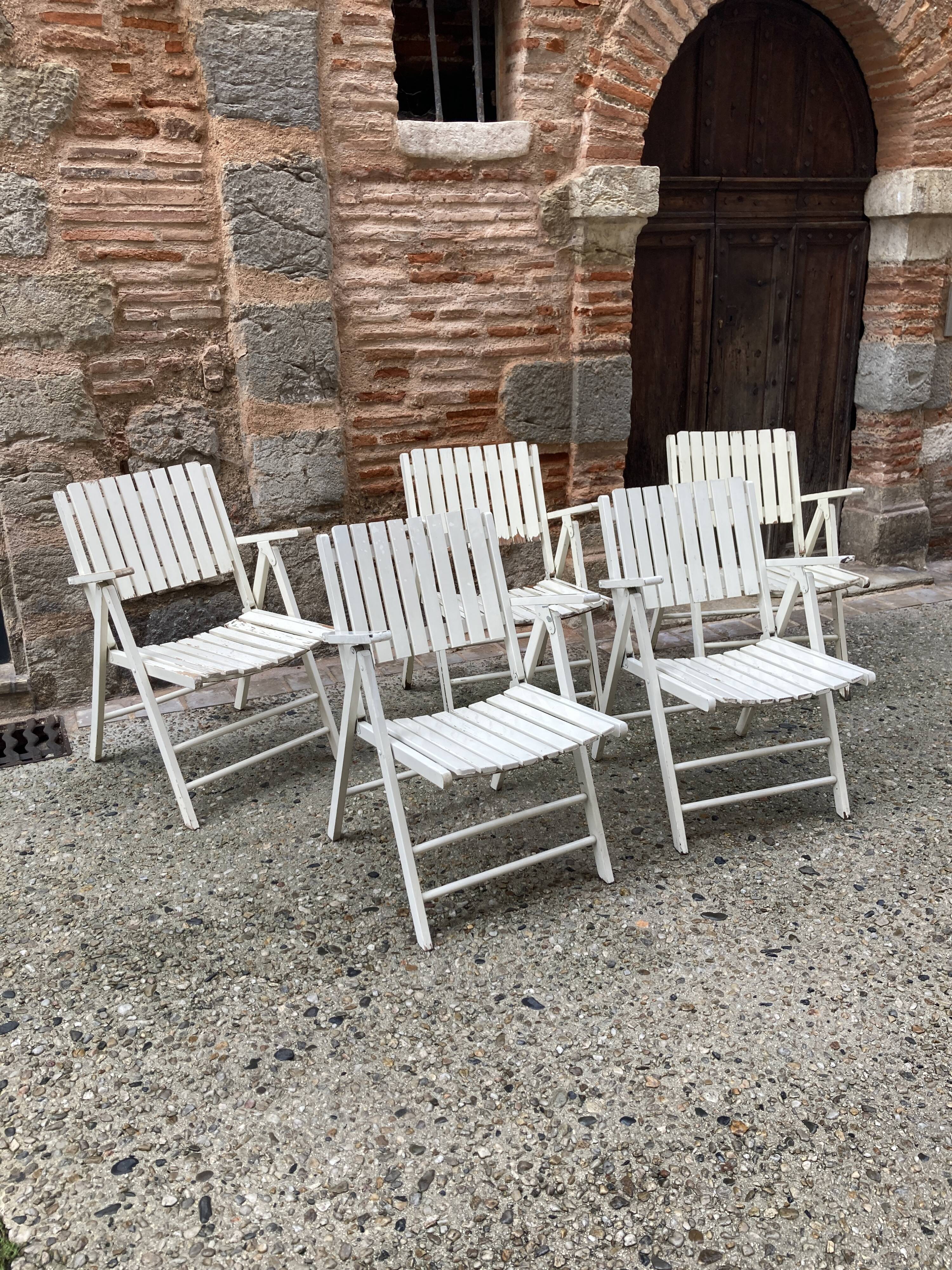 Five wooden garden armchairs