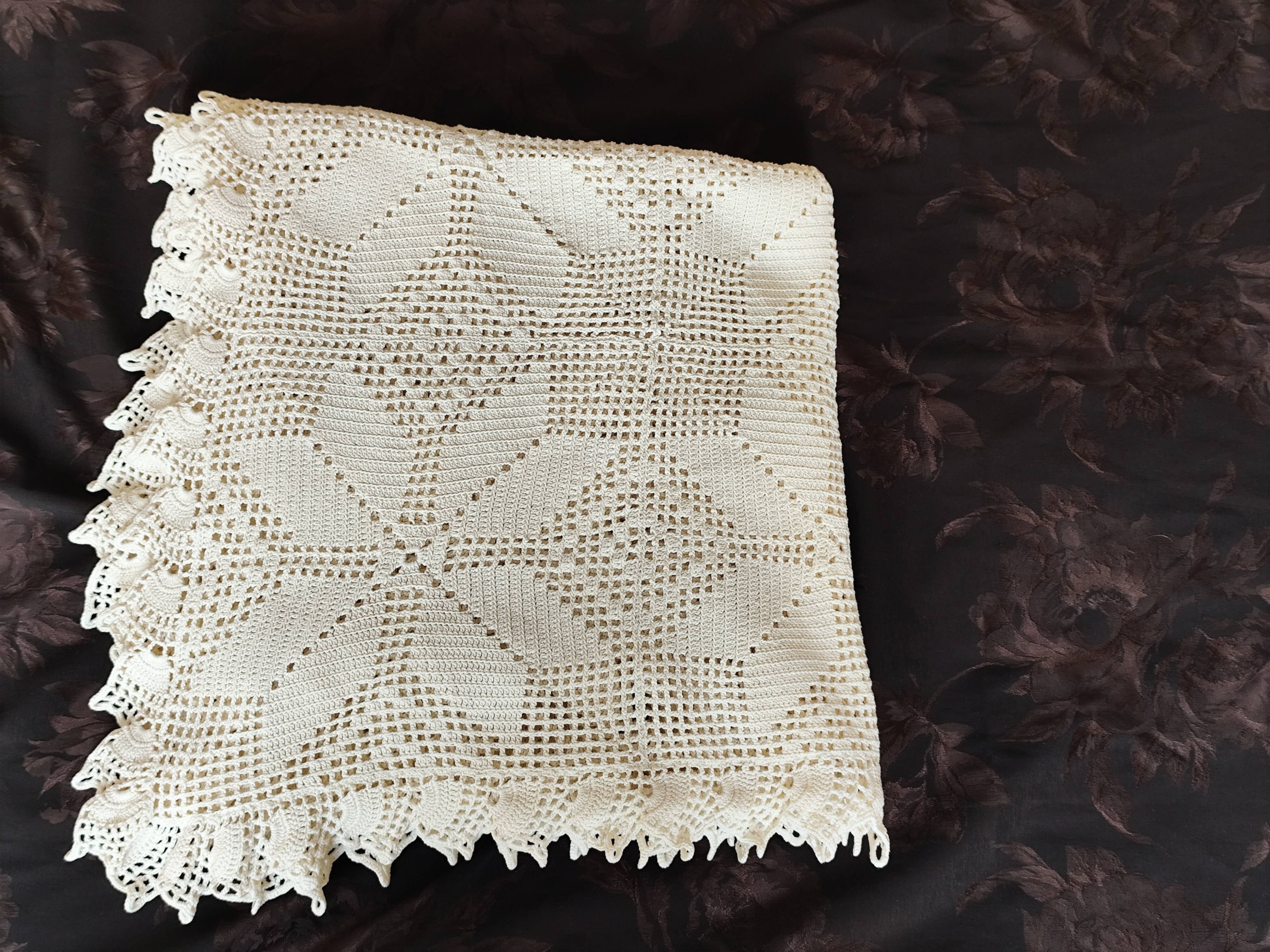 White cotton bedspread, crocheted sofa throw with star patterns