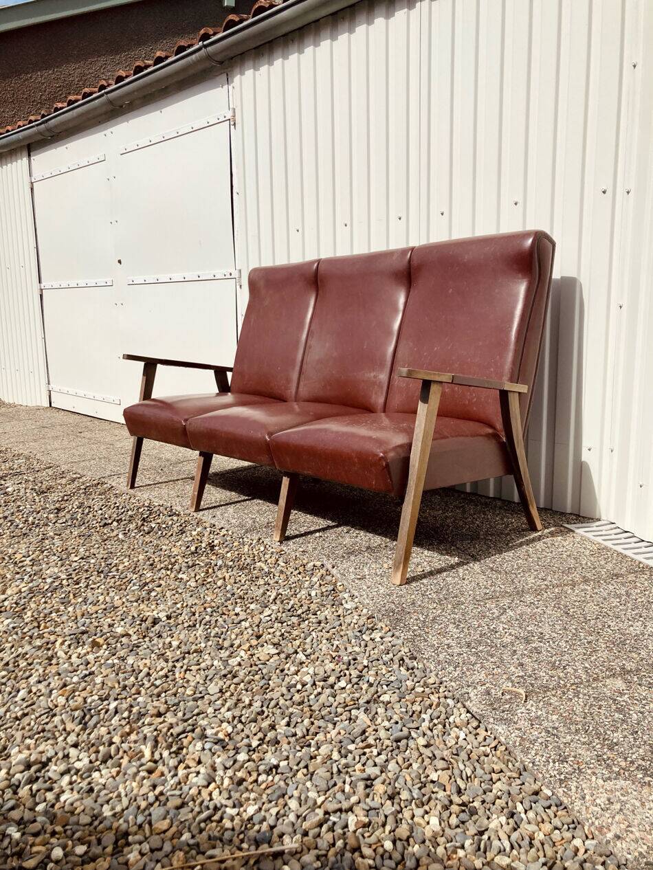 Three-seater patinated leather sofa, mid-century style.