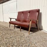 Three-seater patinated leather sofa, mid-century style.