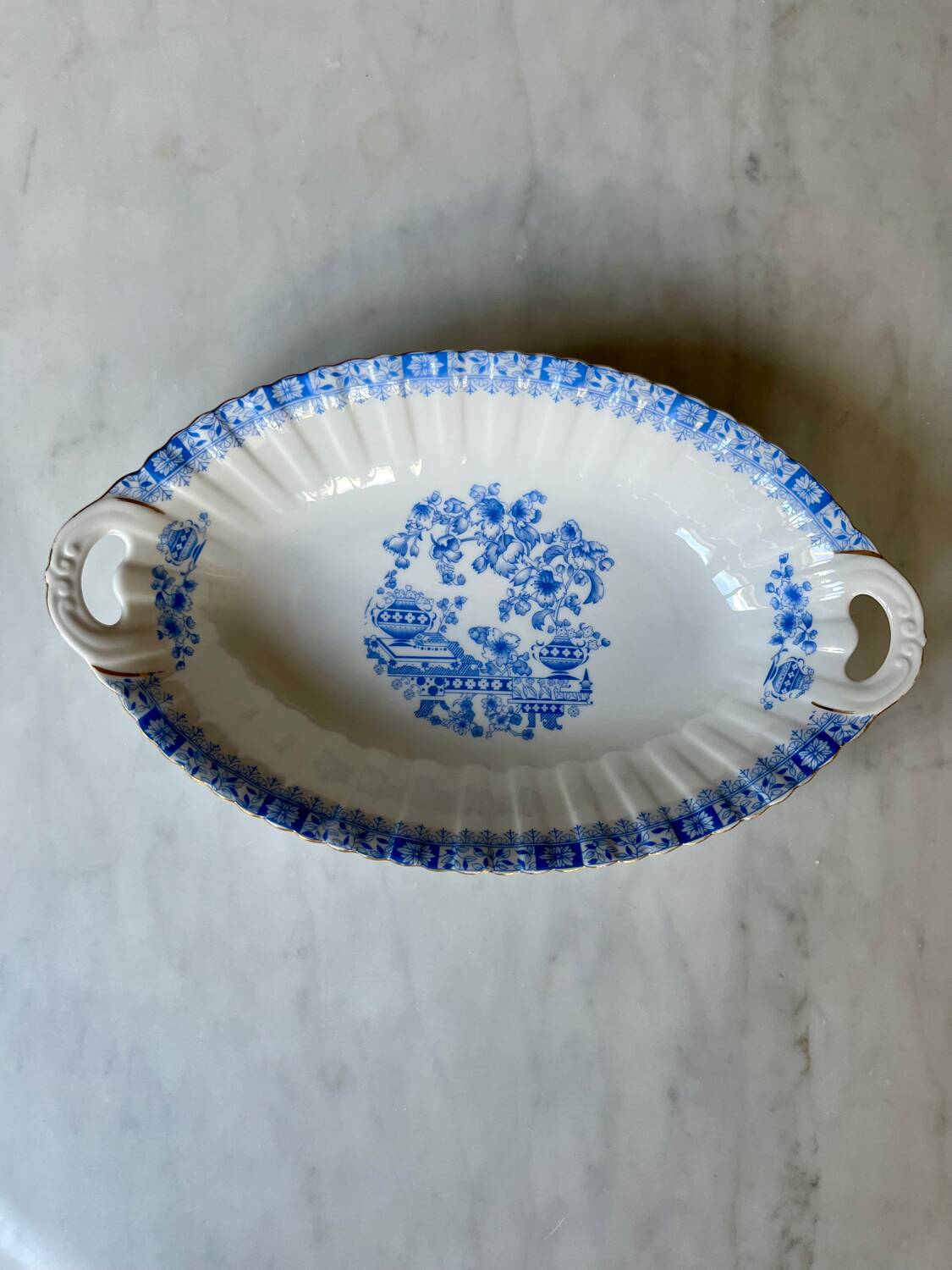 Antique oval dish with handles in earthenware