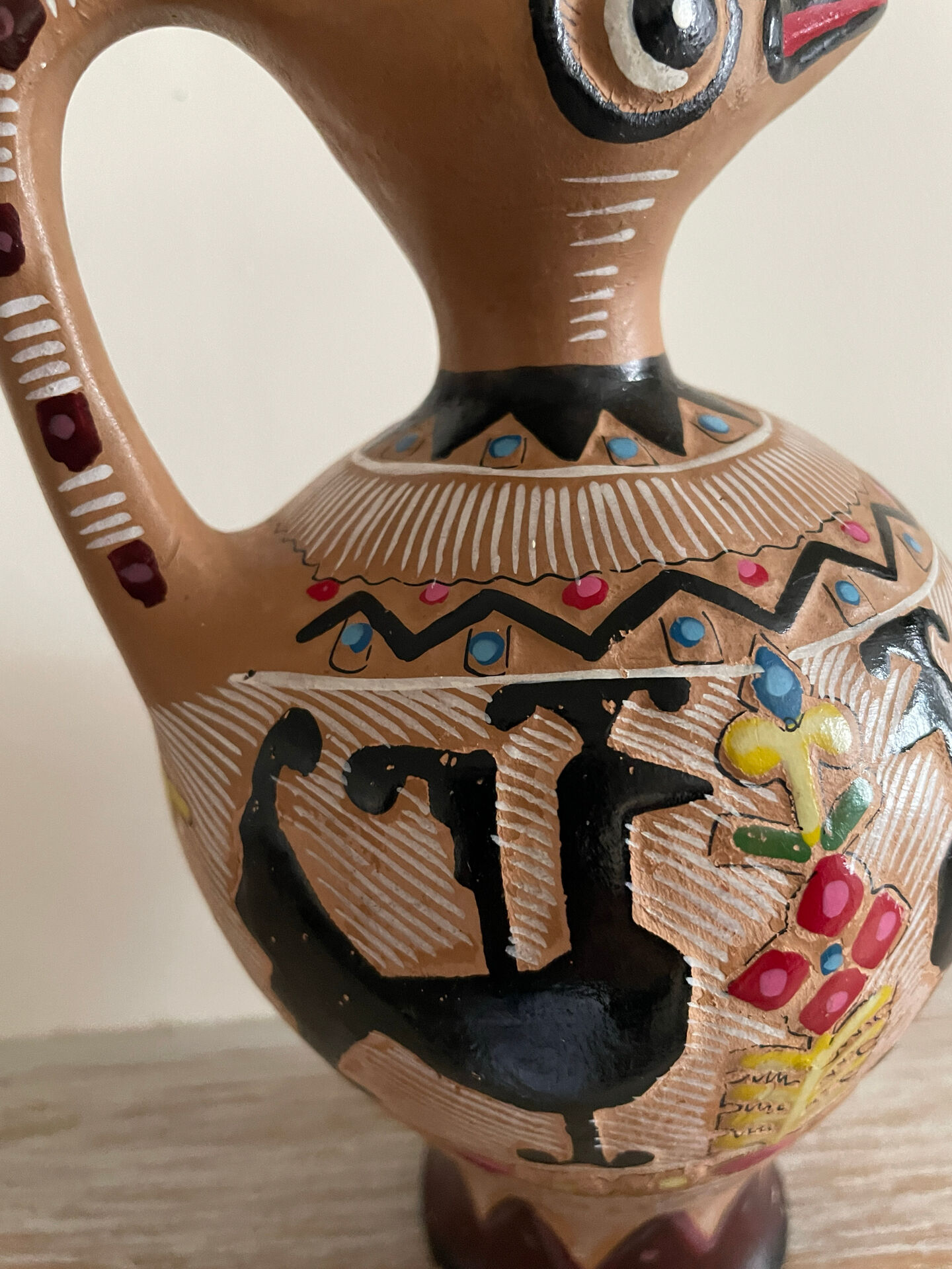 Clay pitcher with a bird head