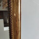 Long wooden mirror and gilded stucco with pearl rays H: 2m45 L: 40cm