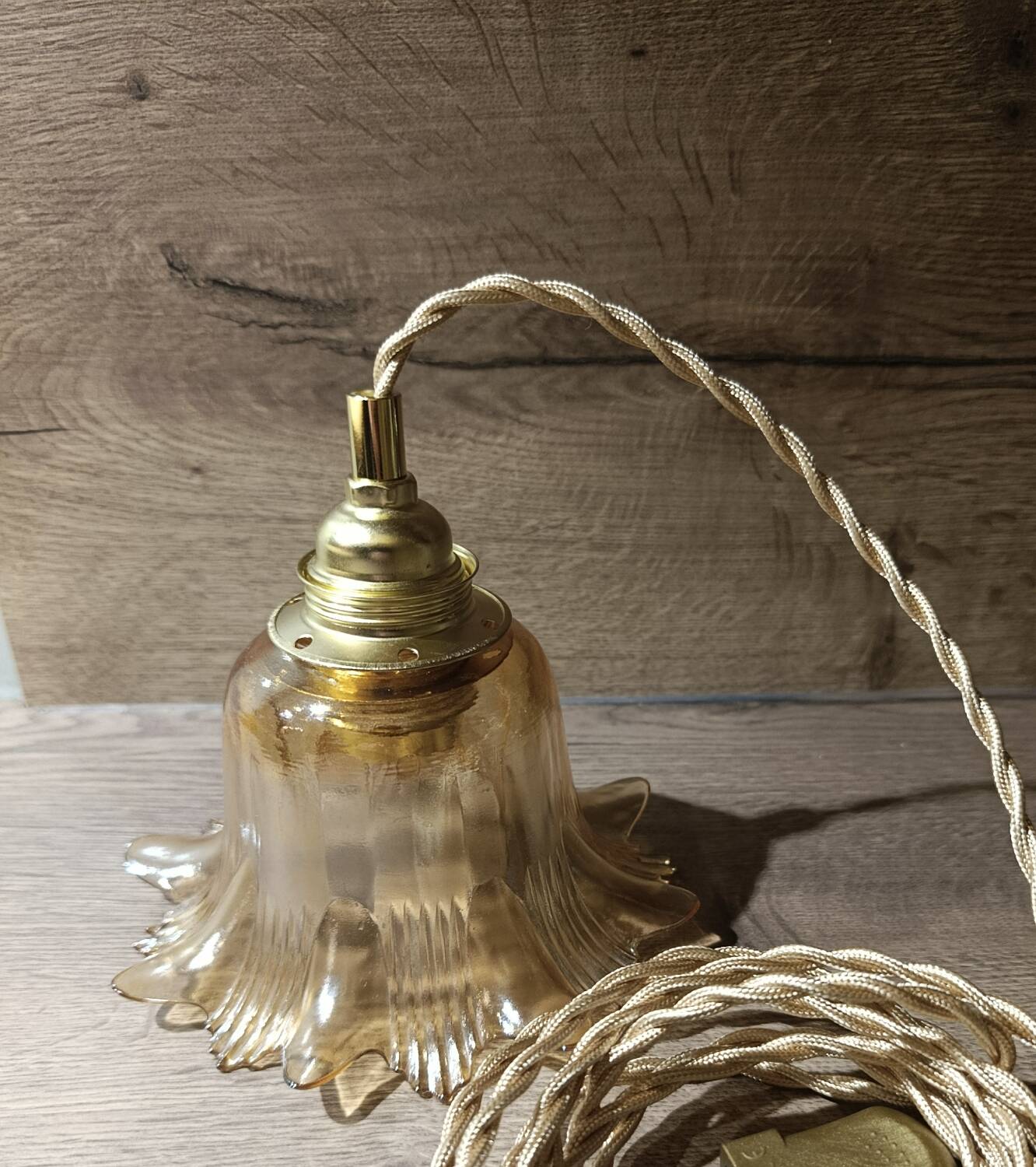 Amber tulip glass portable lamp, golden braided cord.
