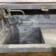 Early 20th-century oak bar counter with period zinc and tin cladding.