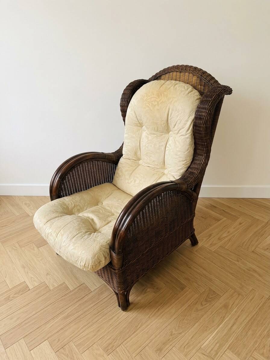 Vintage armchair in rattan and wicker with beige cushion.