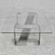 Coffee table with "kinetic" steel base and glass slab. Circa 1970.