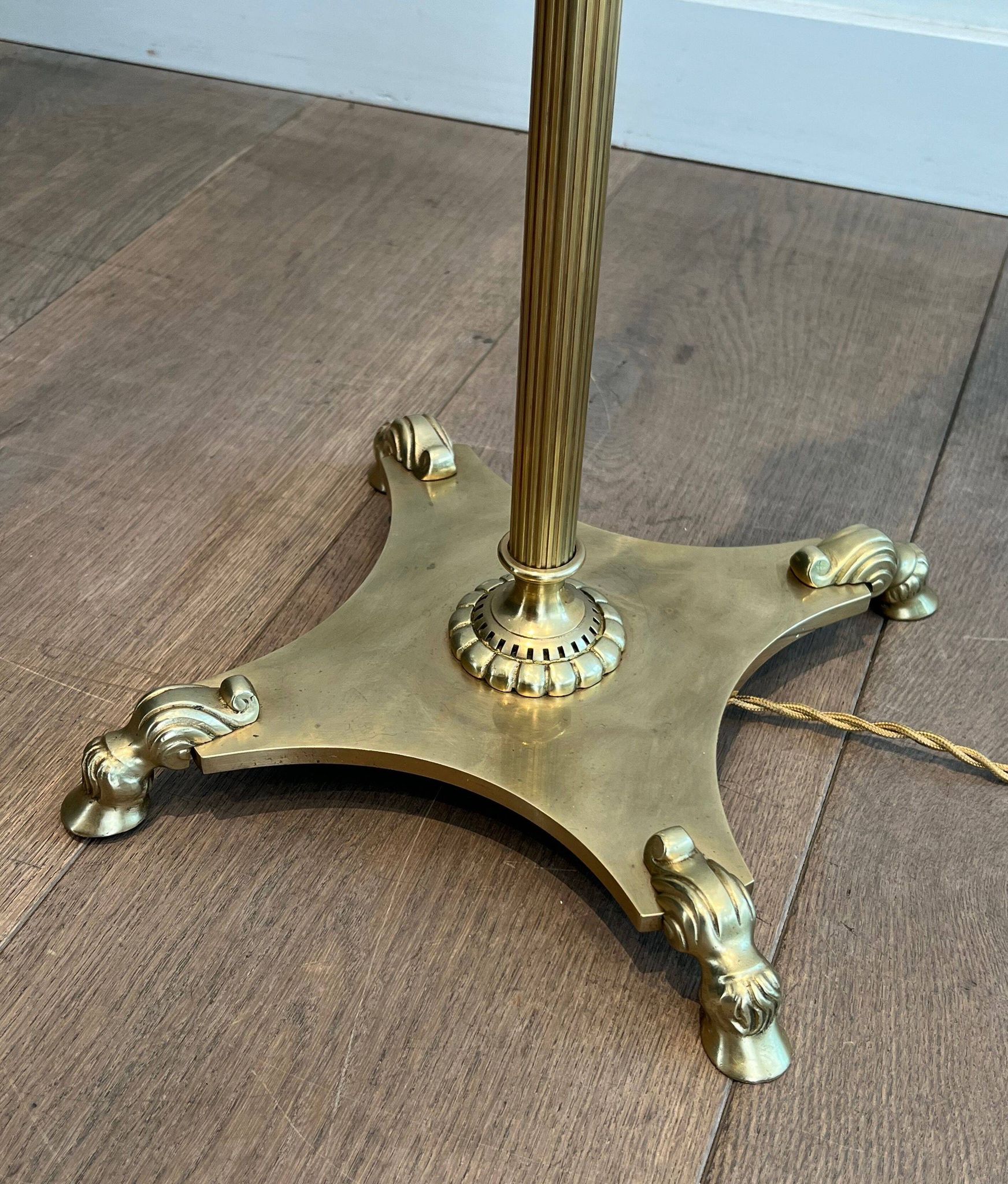 Neoclassical brass floor lamp with claw feet from Maison Jansen.
