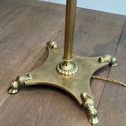 Neoclassical brass floor lamp with claw feet from Maison Jansen.