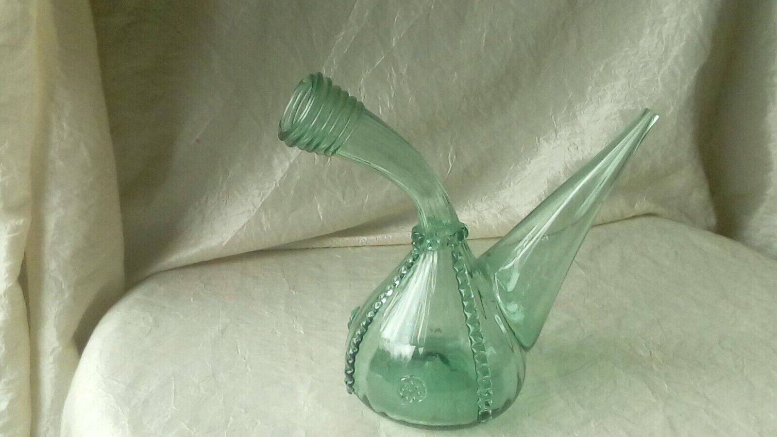 Blown glass carafe with a goat design.