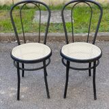 Pair of black steel and plastic cane bistro chairs