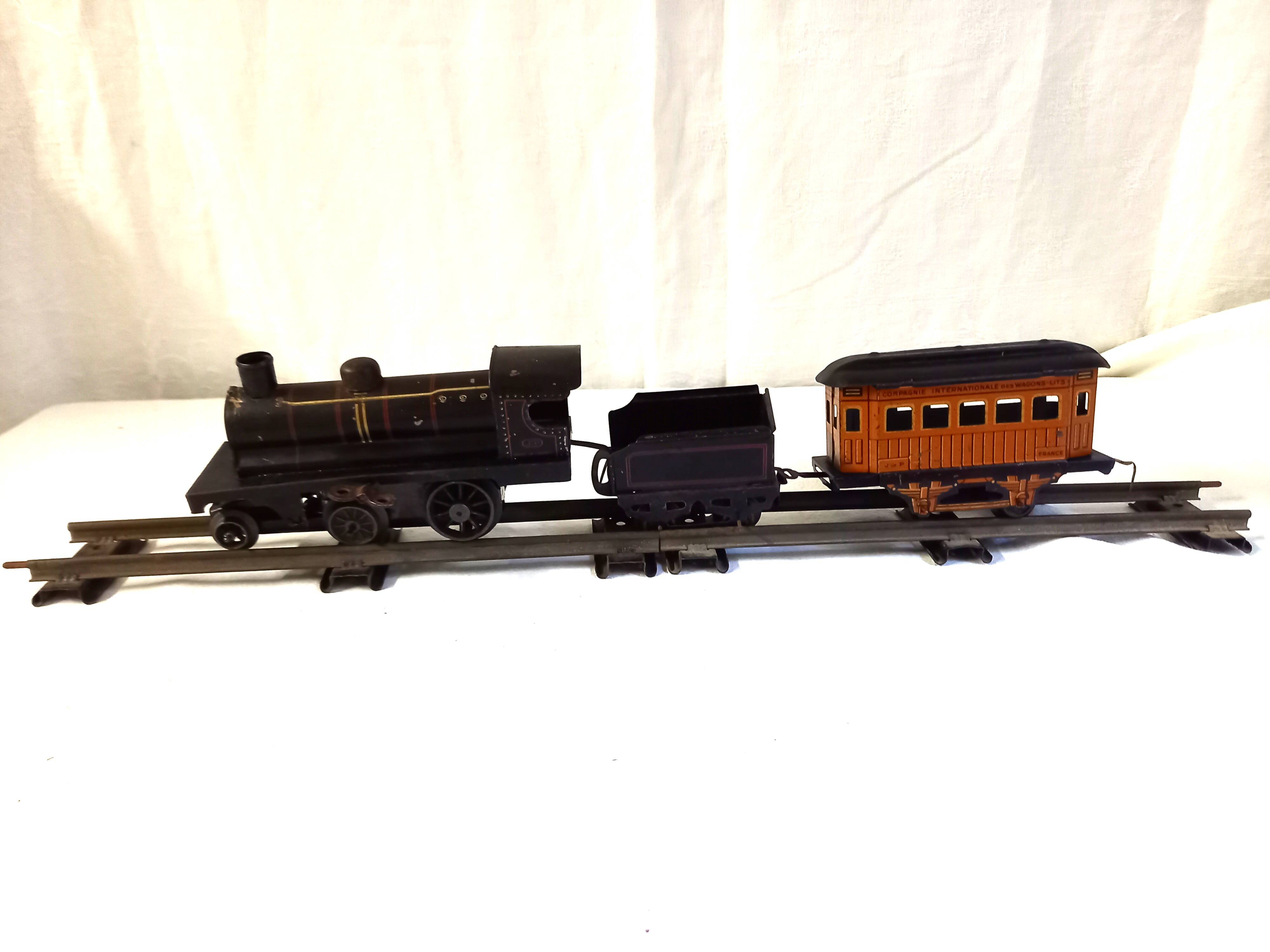 Small JEP mechanical train, including locomotive, tender, sleeping car, rail, 1930s