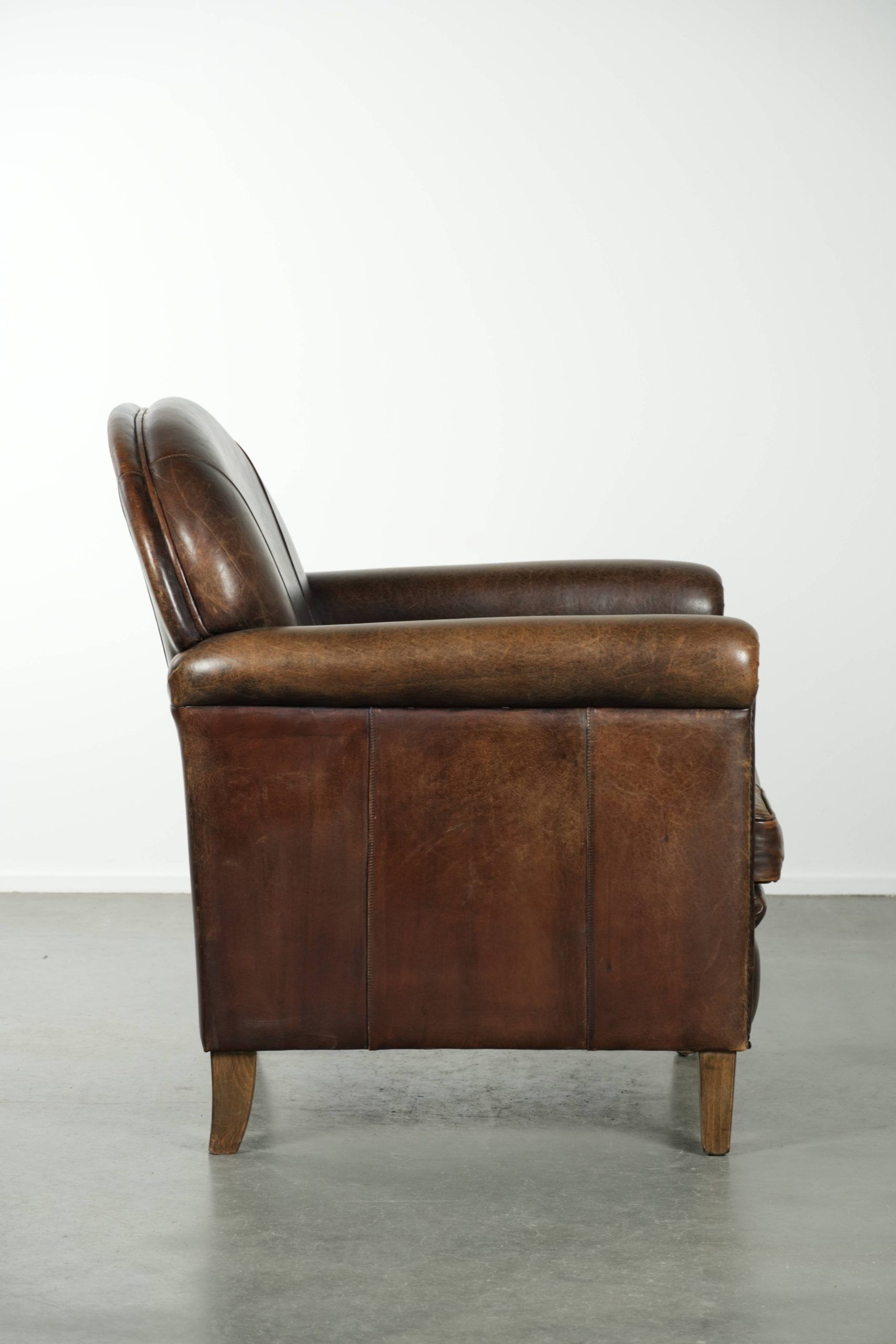 Characterful sheepskin design armchair with beautiful patina