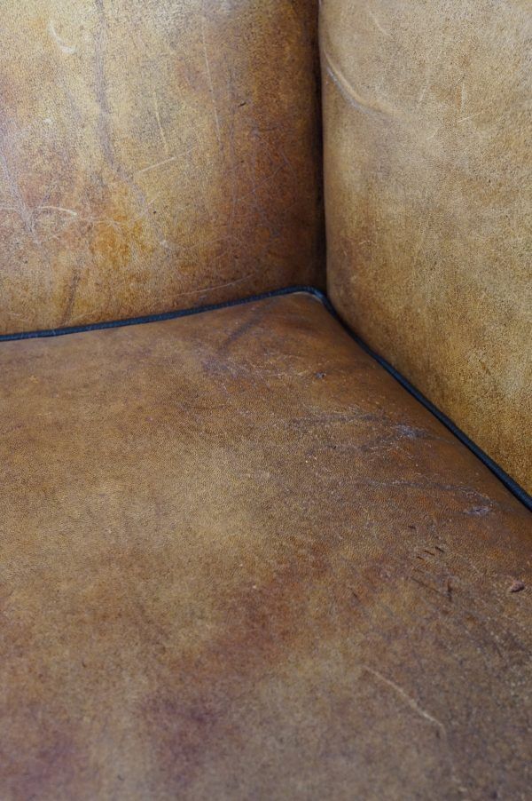 Antique armchair in patinated sheepskin