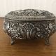 Metal jewelry box inside felt red floral decorations