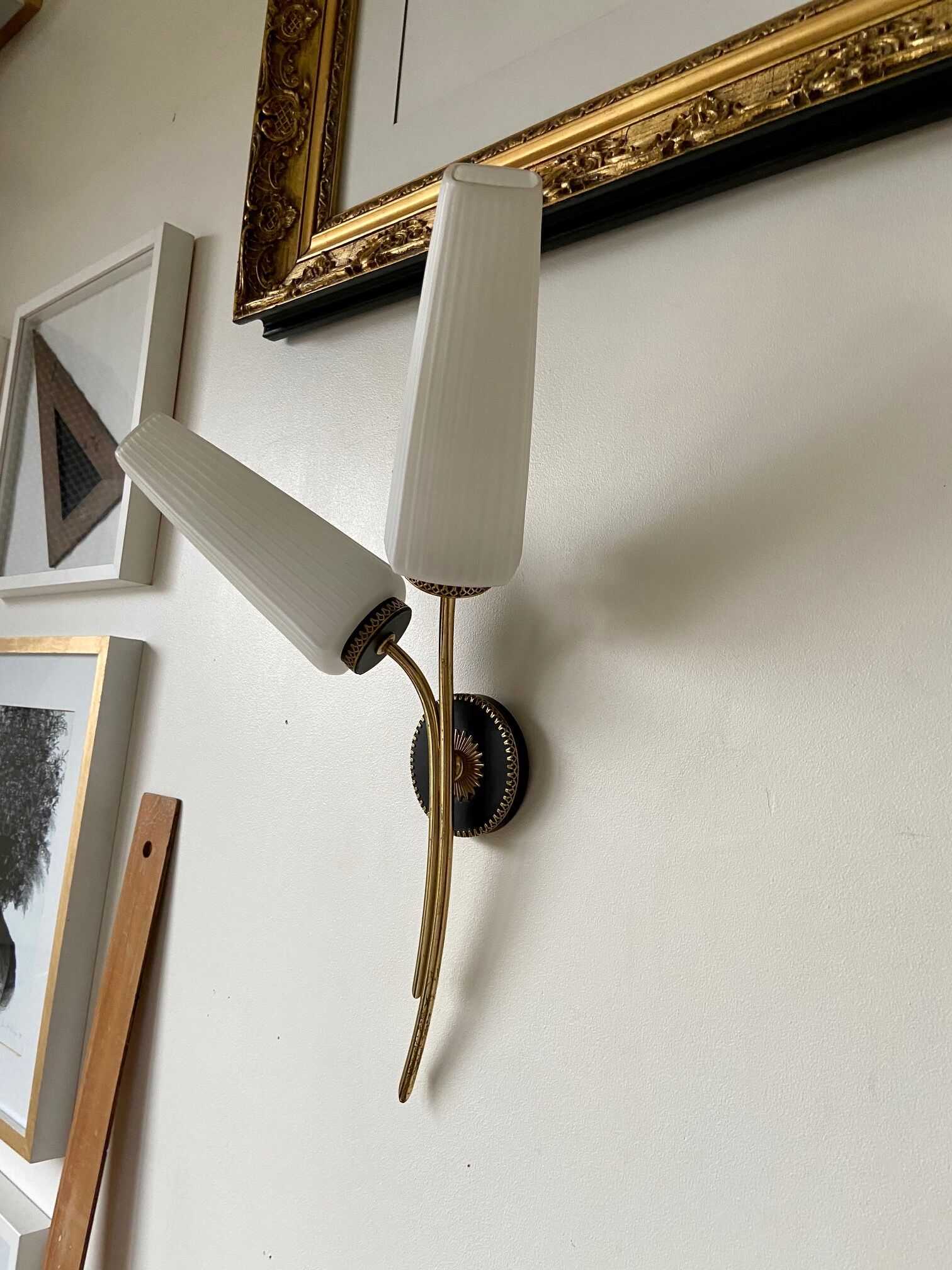 Black and gold metal wall and white opalines sconce