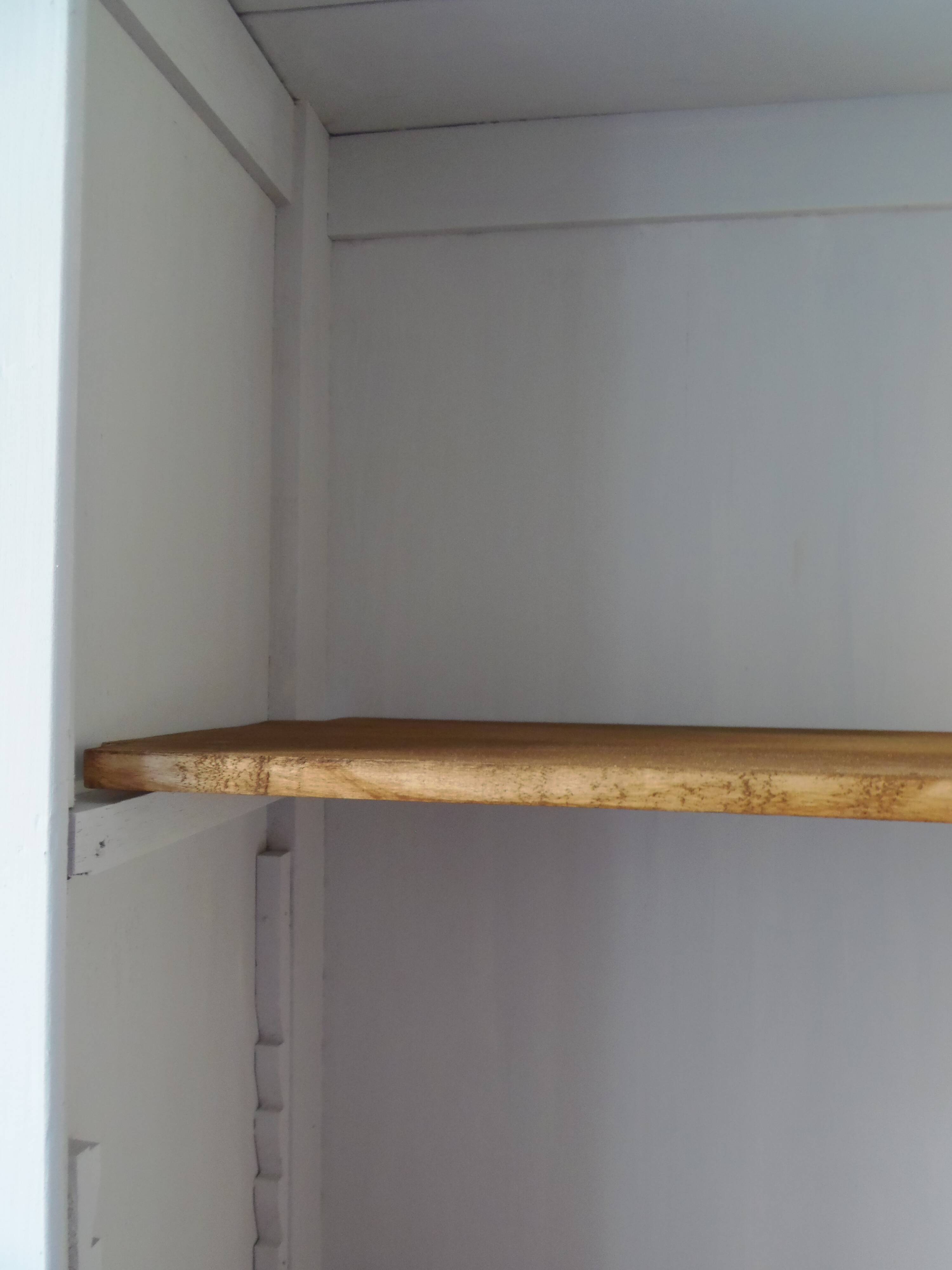 Shallow depth bookcase re-enchanted in pearl gray, wooden shelves.