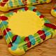 Yellow ceramic trivet and bottle coaster with vintage painted decoration.