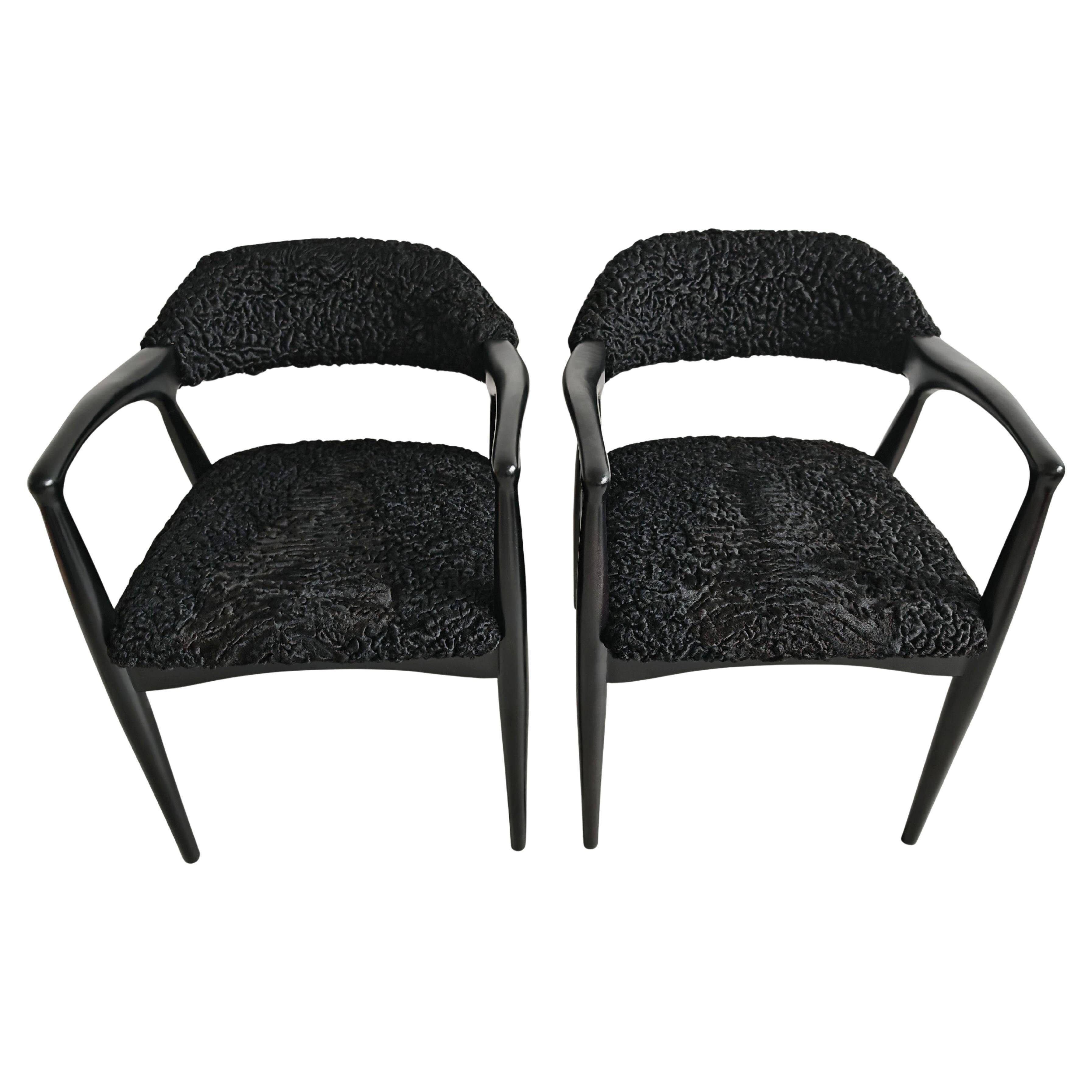 Pair of Mid Century Modern armchairs in astrakhan leather.