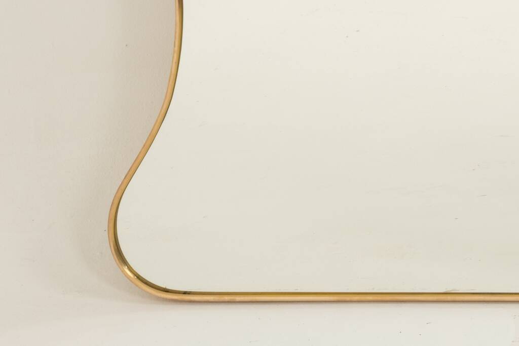 Golden brass mirror in the style of Gio Ponti and the 1980s.