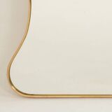Golden brass mirror in the style of Gio Ponti and the 1980s.