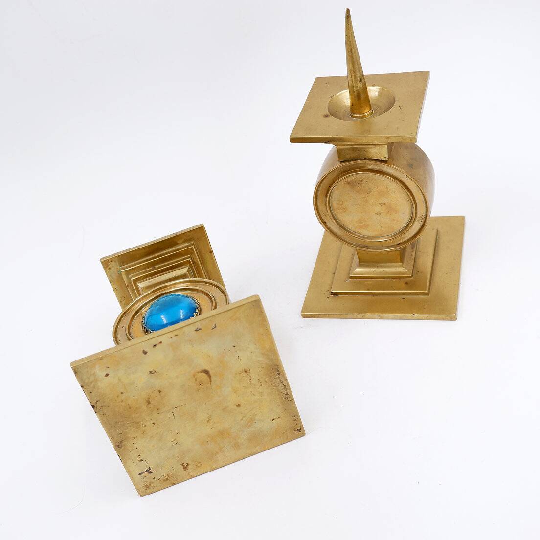 Pair of brass candlesticks decorated with a blue stone inlaid in the center