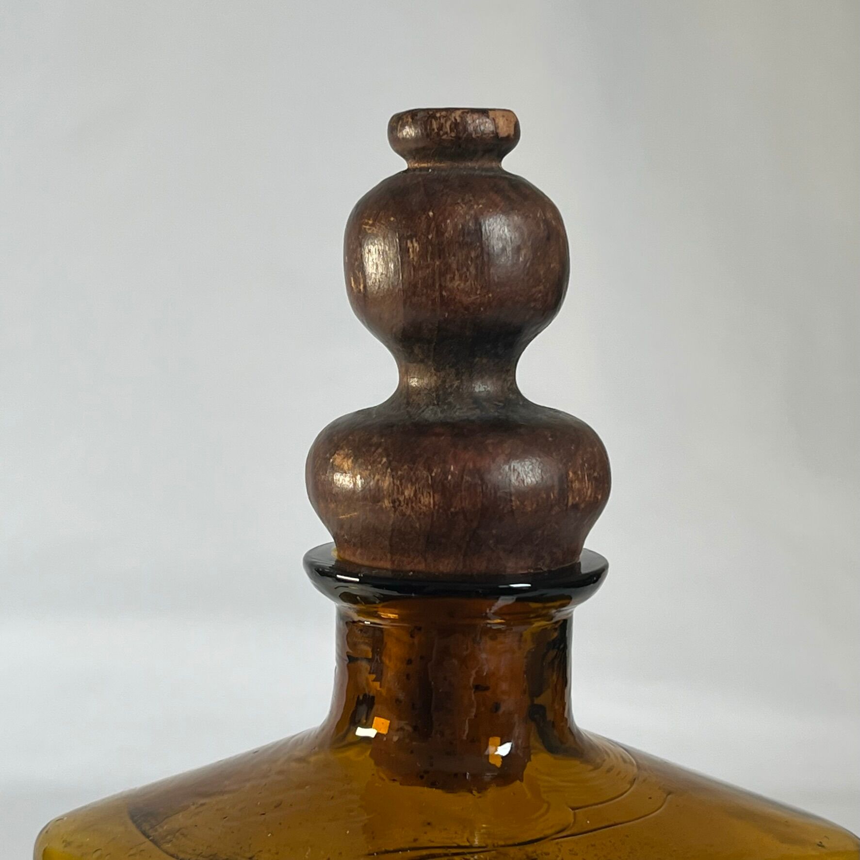 Amber glass and wood bottle