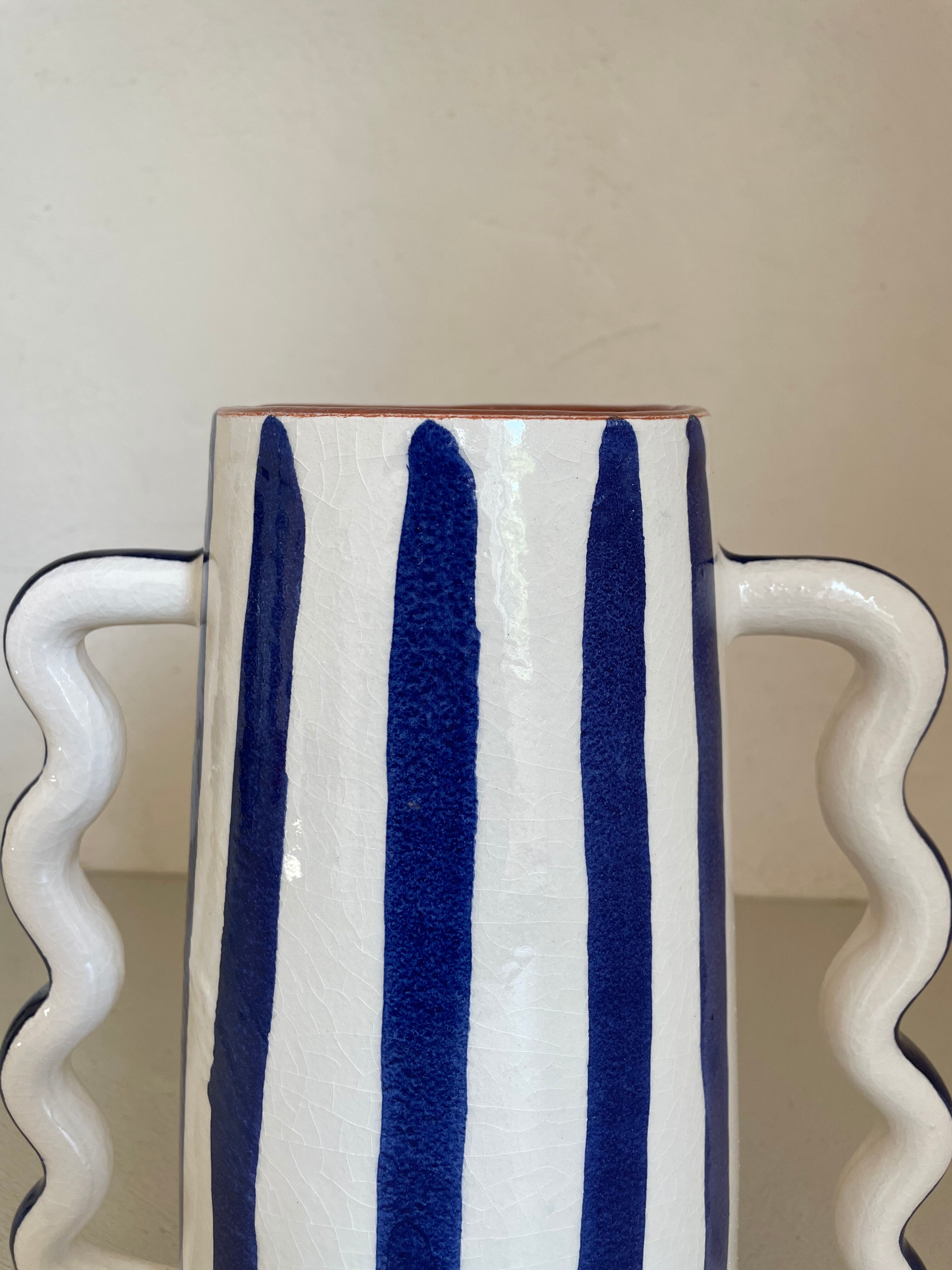 Klein blue and white striped ceramic vase with abstract handmade wavy handles