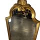 Narrow and tall antique mirror, adorned with golden patterns.