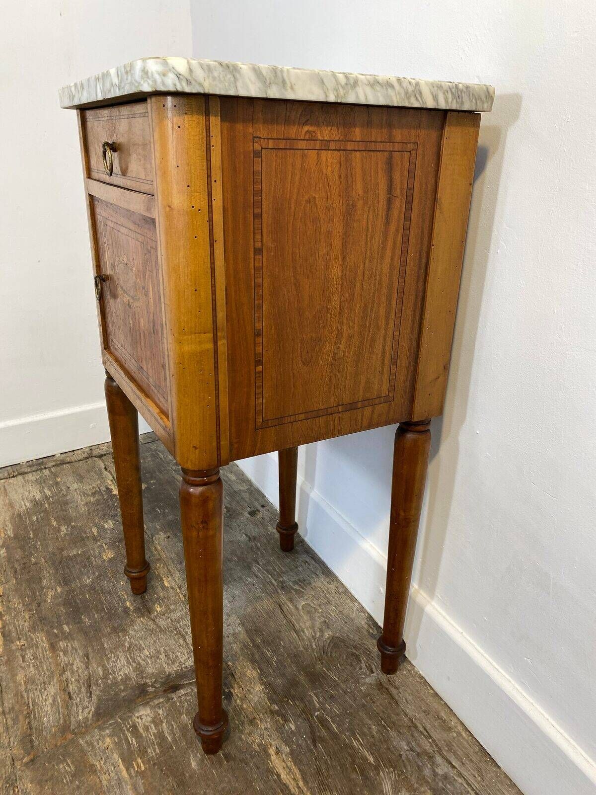 Louis XVI style bedside table, with a marble top and marquetry.