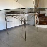 Round table with glass top and ornate metal base