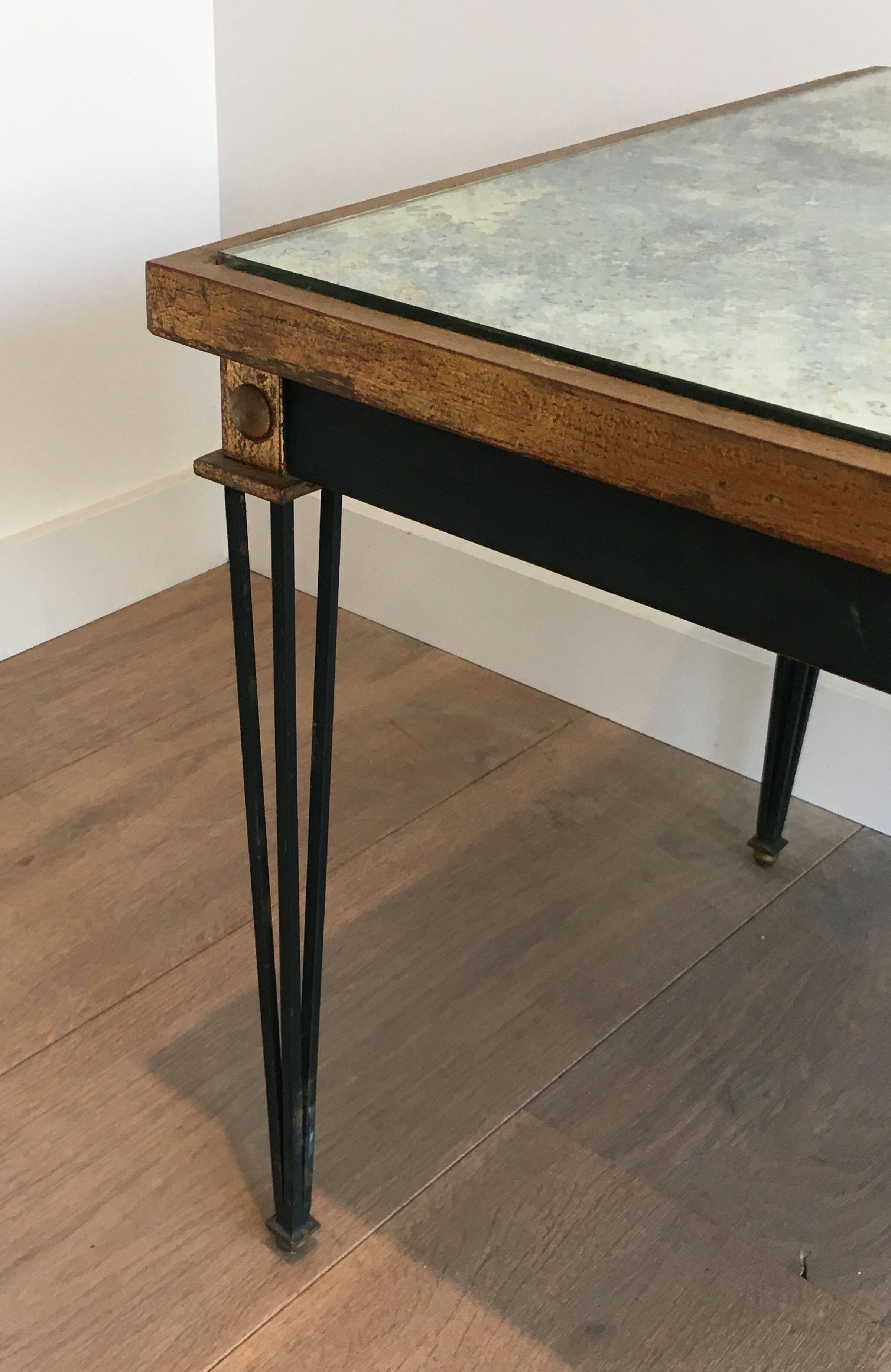 Patinated and gilded steel coffee table in the style of Jacques Quinet.