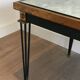 Table basse en acier patiné et doré dans le goût de Jacques Quinet
