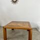 Old coffee table with golden marble top, 70s design, vintage wooden feet