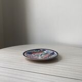 4 colorful flat plates with a fish pattern