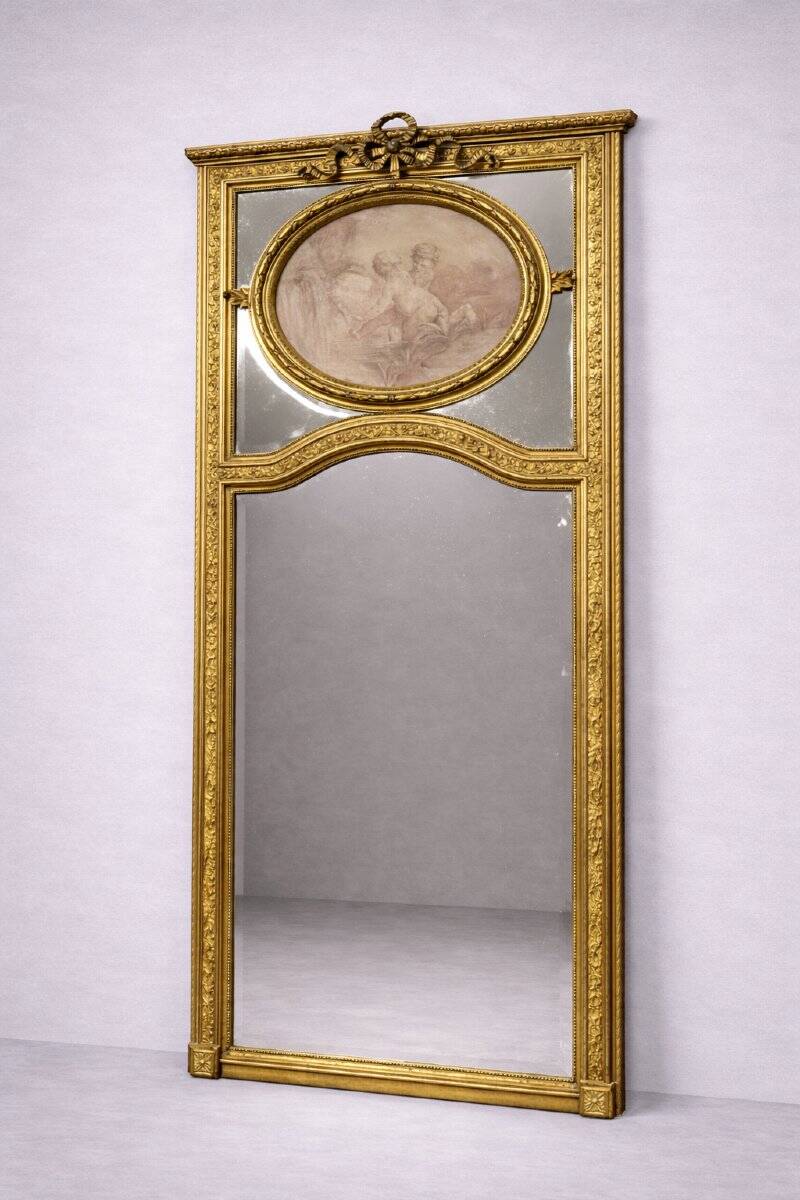 Very large mirror with mouldings, richly carved and gilded, in the Louis XVI style.