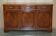 Vintage mahogany buffet with three drawers and shelves.