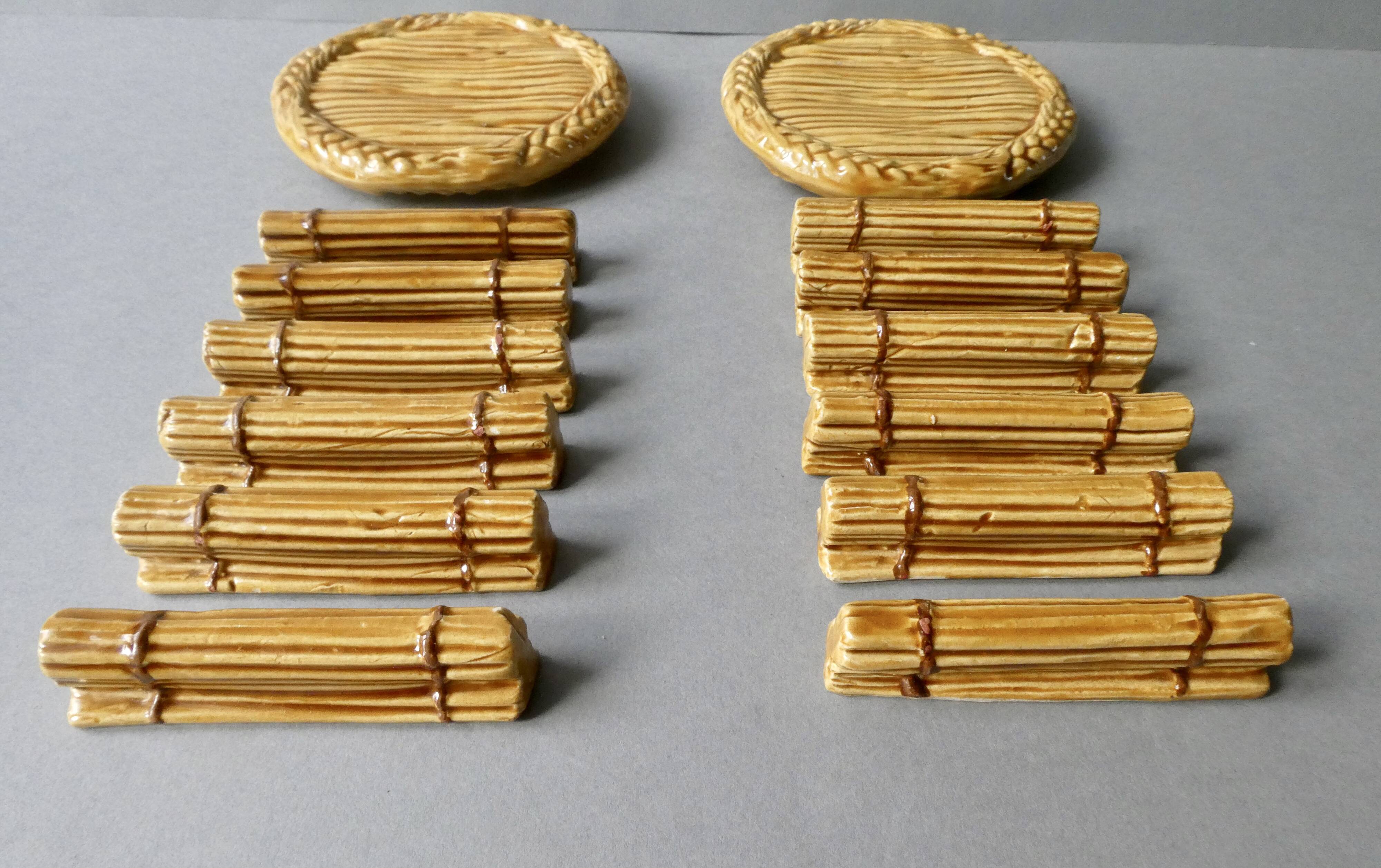 12 knife rests and 2 bottle coasters in earthenware