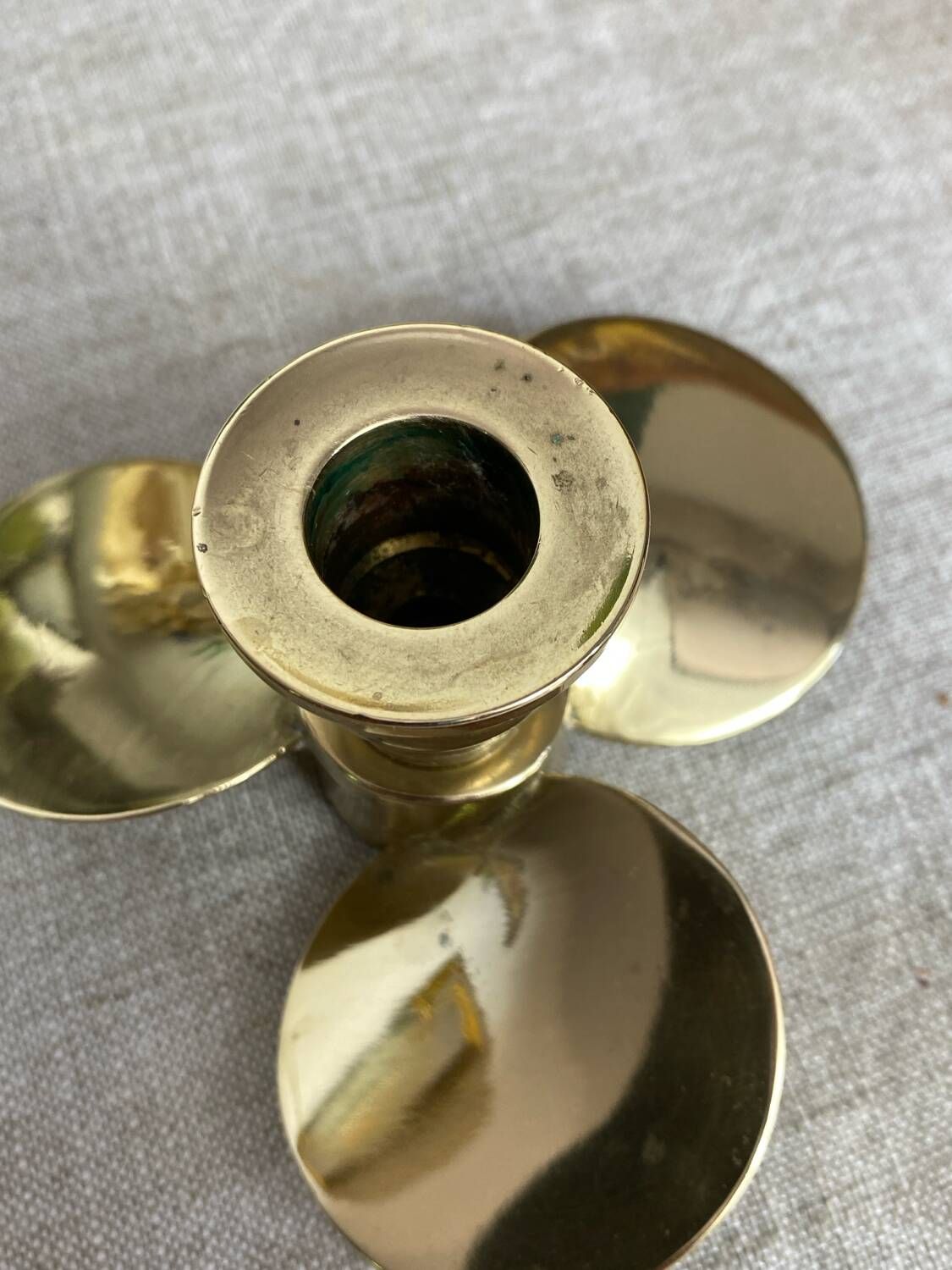 Pair of vintage brass propeller-shaped candlesticks