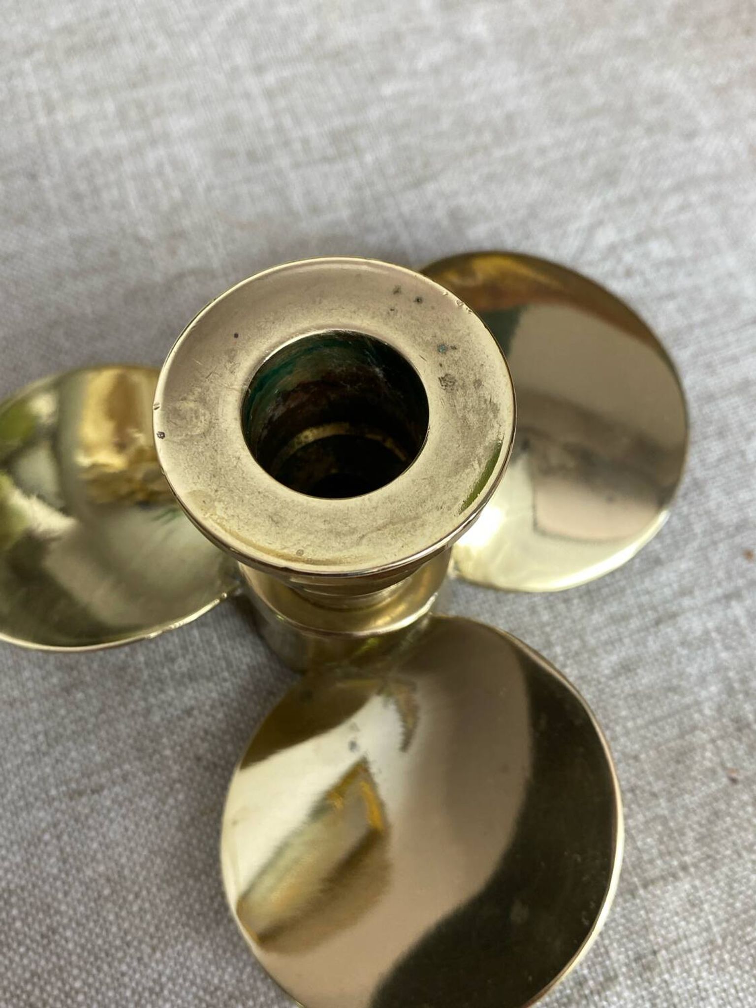 Pair of vintage brass propeller-shaped candlesticks