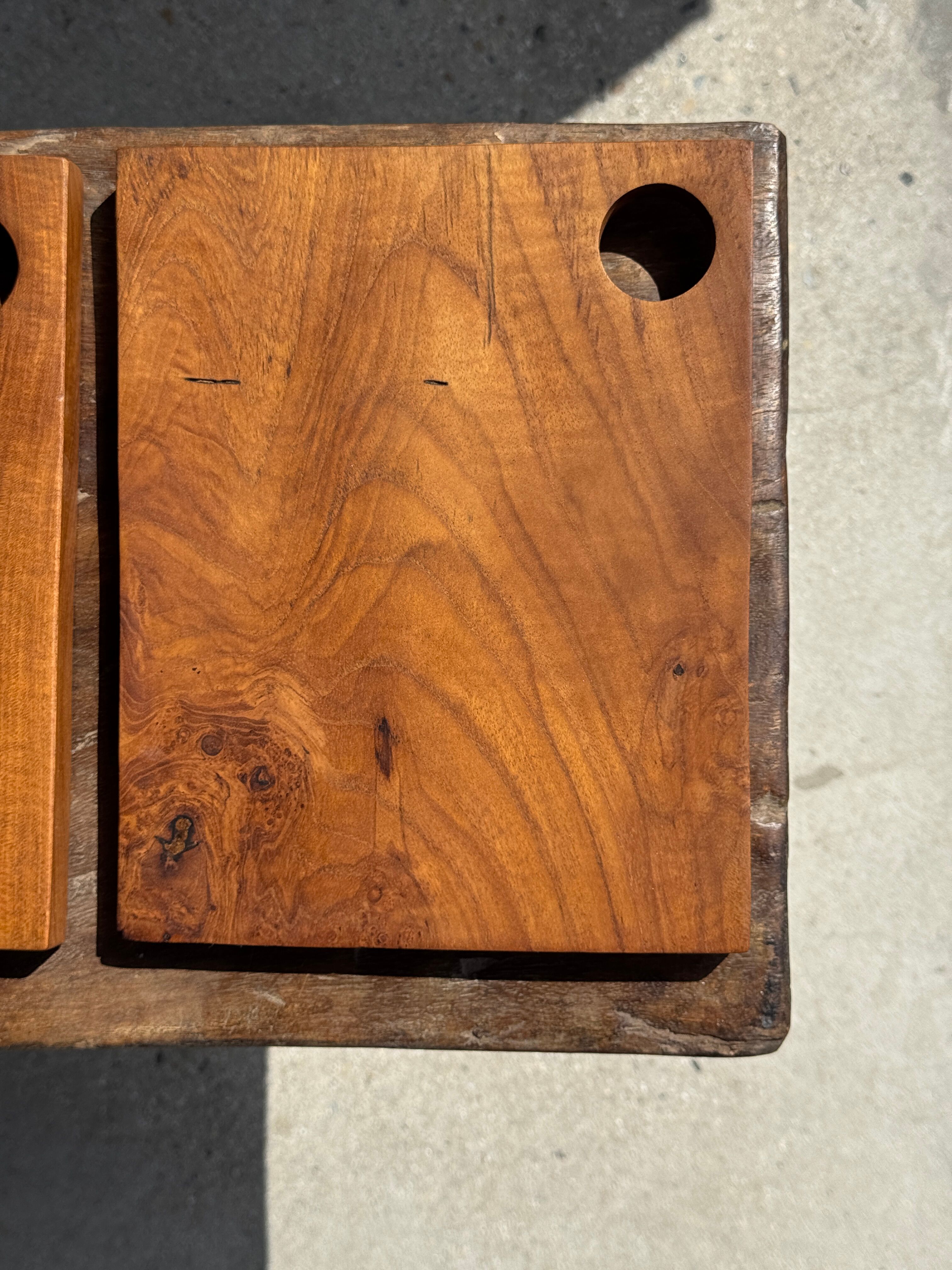 Small rectangular teak monoxyle cutting board with a circular handle.