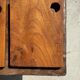 Small rectangular teak monoxyle cutting board with a circular handle.