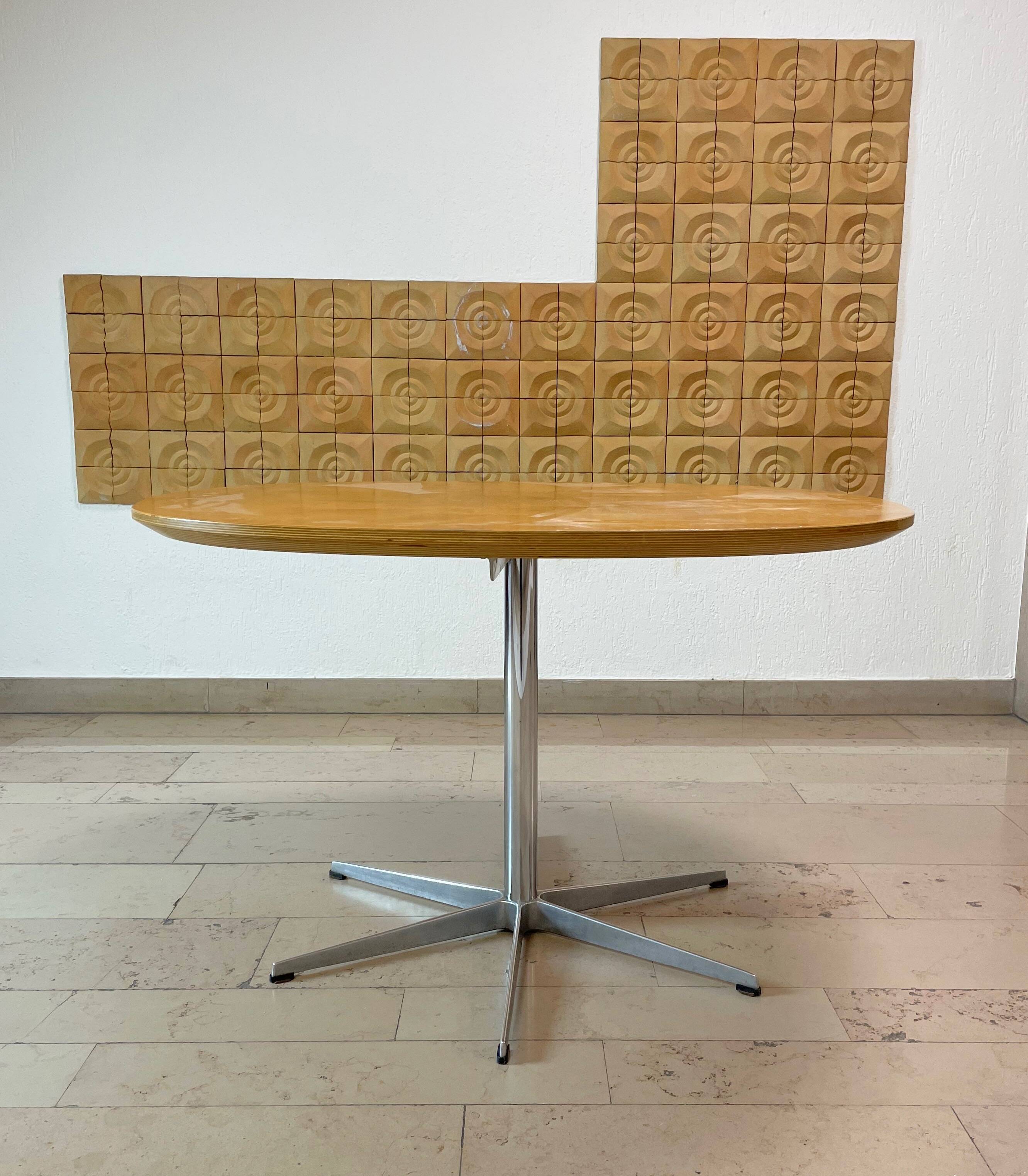 Dining table with a star-shaped six-legged base by Arne Jacobsen for Fritz Hansen.
