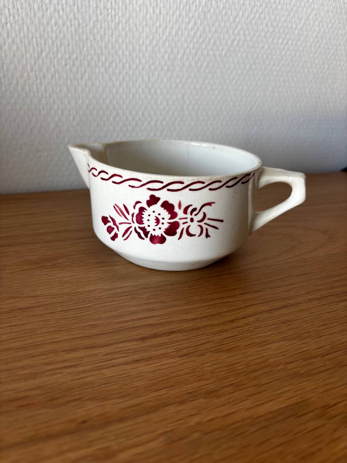 Vintage old sauceboat with pink flowers in St Amand