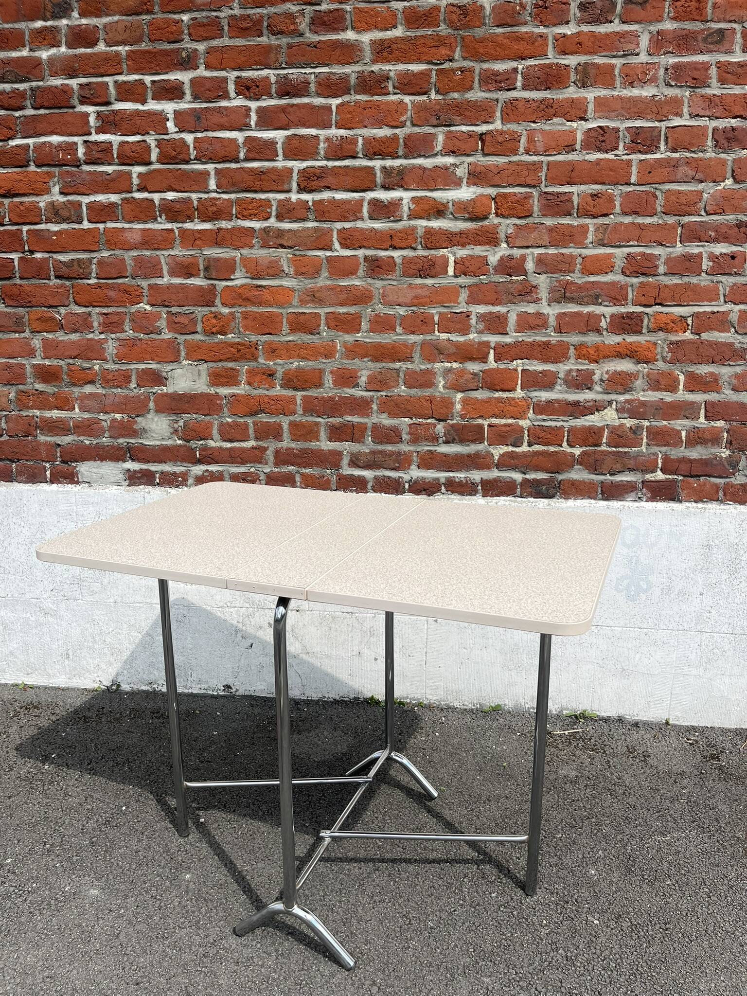 Folding table with chrome and pink formica.