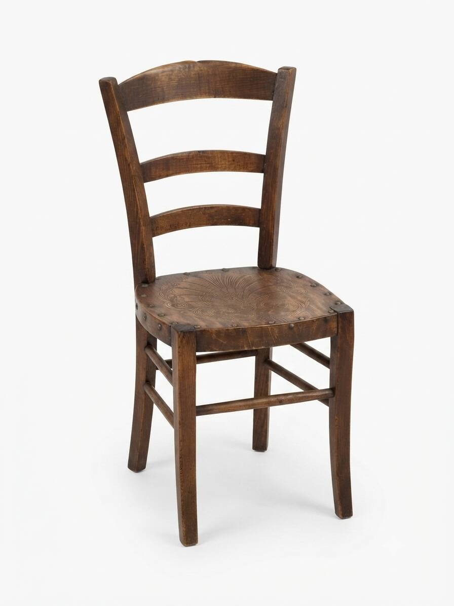 Antique wooden chair with a pyrographed shell motif seat.